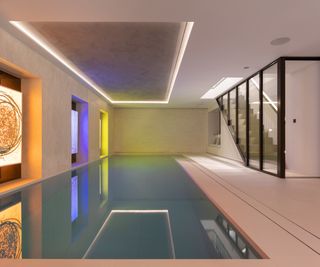 glazed windows and walls between stairwell and large indoor swimming pool