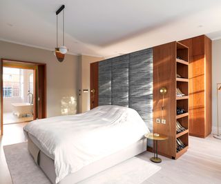 grey bedroom with pale wooden flooring and built in bedroom storage